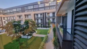 an external view of a building with a courtyard at Embassy gardens Luxury suites CPG in Accra