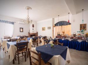 a dining room with tables and chairs with blue table cloth at vila SEJUDA Alberghetto in Peschici