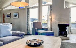 a living room with a couch and a fireplace at Holiday Home Hvide Sande 36 in Hvide Sande