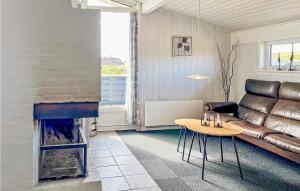 a living room with a couch and a fireplace at Holiday Home Hvide Sande 36 in Hvide Sande
