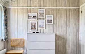 a room with a wooden wall with pictures on it at Holiday Home Hvide Sande 36 in Hvide Sande