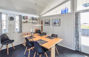a dining room with a table and chairs at Holiday Home Hvide Sande 36 in Hvide Sande +7 photos