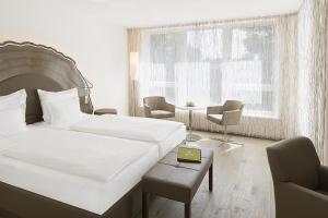 Rúm í herbergi á Taome Feng Shui Stadthotel Breisgau