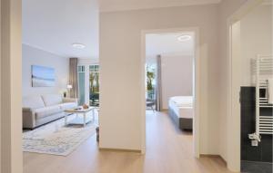a bedroom with a bed and a living room at Baltischer Hof Apartment 43 in Boltenhagen