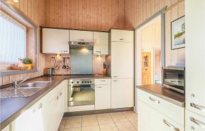a kitchen with white cabinets and a sink at Amazing Home In Rechlin With Wifi in Rechlin