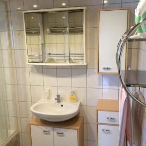 a bathroom with a sink and a mirror at Harmónia Vendégház in Poroszló