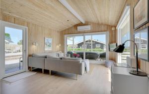 a living room with a couch and a tv at Three-Bedroom Holiday Home In Bjert in Binderup Strand