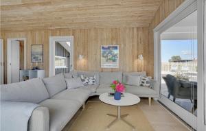 a living room with a couch and a table at Three-Bedroom Holiday Home In Bjert in Binderup Strand