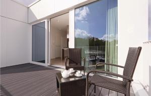 a balcony with two chairs and a table on a building at Priwallpromenade 23, Whg 11 in Travemünde +29 photos