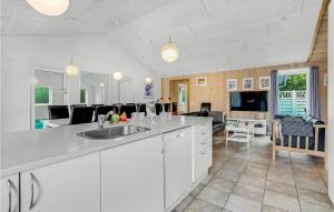 a kitchen with a sink and a living room at 7 Bedroom Gorgeous Home In Vinderup in Vinderup +22 photos
