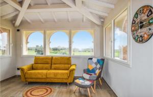 a living room with a yellow couch and two chairs at 6 Bedroom Beautiful Home In Bibbona in Bibbona