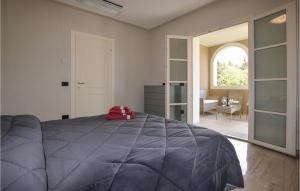 a bedroom with a bed with a red pillow on it at 6 Bedroom Beautiful Home In Bibbona in Bibbona