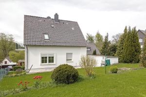 a white house with a green yard at Haus am Garten in Brunkensen