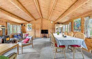 a dining room with a table and chairs at Four-Bedroom Holiday Home In Otterup in Otterup