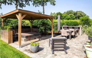 a patio with a gazebo and a table and chairs at Gorgeous Home In Wemeldinge With Wifi in Wemeldinge +25 photos