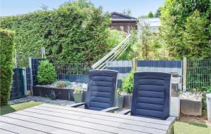 a garden with two chairs and a wooden table at Lovely Home In Diemelsee Ot Sudeck in Rhenegge