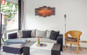 a living room with a couch and a table at Lovely Home In Diemelsee Ot Sudeck in Rhenegge
