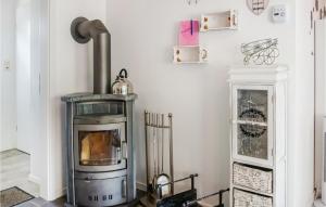 a living room with a wood stove in the corner at Lovely Home In Diemelsee Ot Sudeck in Rhenegge +12 photos