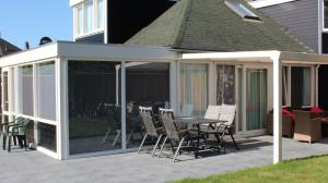 - un pavillon avec une table et des chaises sur la terrasse dans l'établissement Nettes Ferienhaus in Stavenisse mit Terrasse und Grill, à Stavenisse