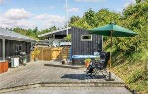 a patio with a table and an umbrella at Two-Bedroom Holiday Home In Ebeltoft in Ebeltoft +24 photos