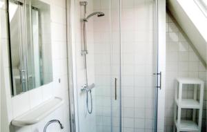 a shower with a glass door in a bathroom at Verzicht in Den Oever