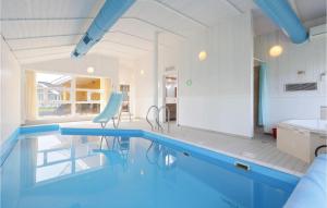 a large swimming pool in a room with a kitchen and a sink at Strandblick 11 in Schönhagen +25 photos