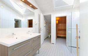 a bathroom with two sinks and a large mirror at Strandblick 11 in Schönhagen
