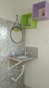a bathroom with a sink and a mirror at Casa na histórica - Santana de Parnaíba SP in Santana de Parnaíba