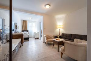a living room with a couch and a bedroom at Hotel Adrović in Sveti Stefan