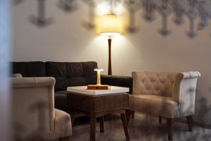 a living room with a couch and a table and a chair at Hotel Adrović in Sveti Stefan
