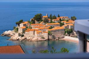 a small town on an island in the water at Hotel Adrović in Sveti Stefan
