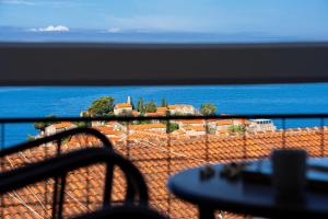 a view of the ocean from a balcony at Hotel Adrović in Sveti Stefan