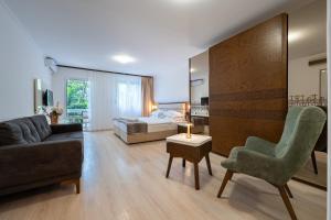 a living room with a couch and a bed at Hotel Adrović in Sveti Stefan