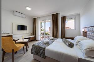a hotel room with a bed and a television at Hotel Adrović in Sveti Stefan