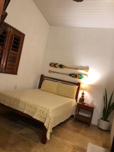 a bedroom with a bed and a shelf on the wall at Casa Girasol in Trairi