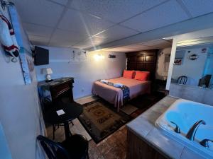 a bedroom with a bed and a tub and a sink at Green Dolphin in Old Orchard Beach