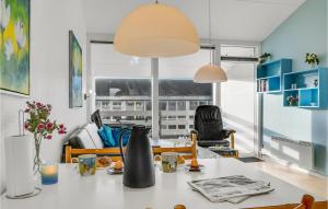 a kitchen and living room with a table and chairs at 3 Bedroom Cozy Apartment In Ringkøbing in Ringkøbing
