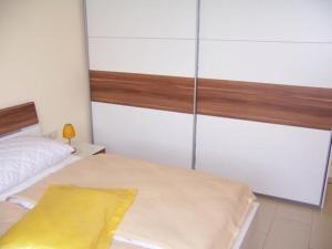 a bedroom with a bed with a yellow blanket on it at Ferienwohnung Kammblick in Bad Mitterndorf in Bad Mitterndorf