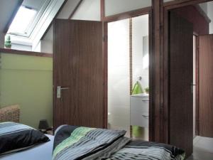 a bedroom with a bed and a sliding glass door at Familienfreundliches Ferienhaus in Frielendorf in Frielendorf +9 photos