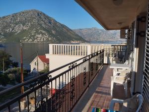 a balcony with a view of the water and mountains at Amarillys in Donji Morinj
