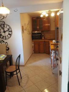 a kitchen with a table and a refrigerator at Amarillys in Donji Morinj