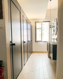 a kitchen with a pivot door and a tile floor at Betel Box Backpackers Hostel in Singapore