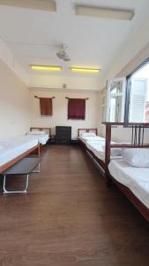 a large room with several beds in it at Betel Box Backpackers Hostel in Singapore