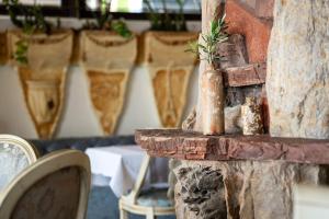 a stone table with a vase on top of it at Hotel Adrović in Sveti Stefan