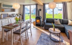 a living room with a couch and a table and a fireplace at Lovely Home In Zerpenschleuse With Wifi in Zerpenschleuse