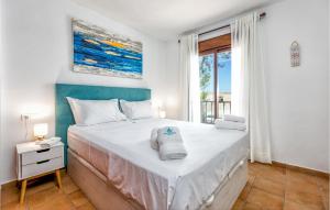 a bedroom with a large bed and a window at Gorgeous Home In Marbella With Kitchen in Marbella
