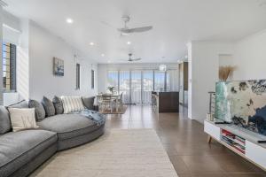 a living room with a couch and a tv at Villa Sangiovese - Unit Two - 2-2 Heath Street in Evans Head