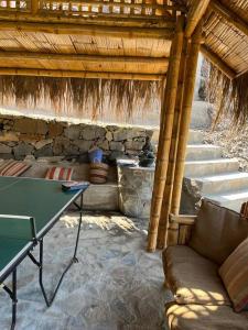 a room with a couch and a table and some stairs at Cabaña de Campo Huaral, hermosas vistas Piscina in Huaral