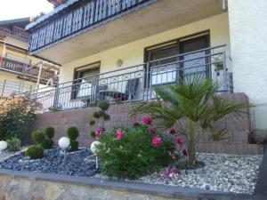 ein Garten vor einem Haus mit Blumen in der Unterkunft Schäfers Ferienwohnung Oberdiebach am Mittelrhein in Oberdiebach
