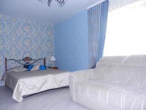 a blue bedroom with two beds and a window at Apartment na Revolutsii in Voronezh